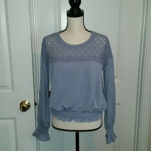 Lace pullover top with ruffle sleeves.